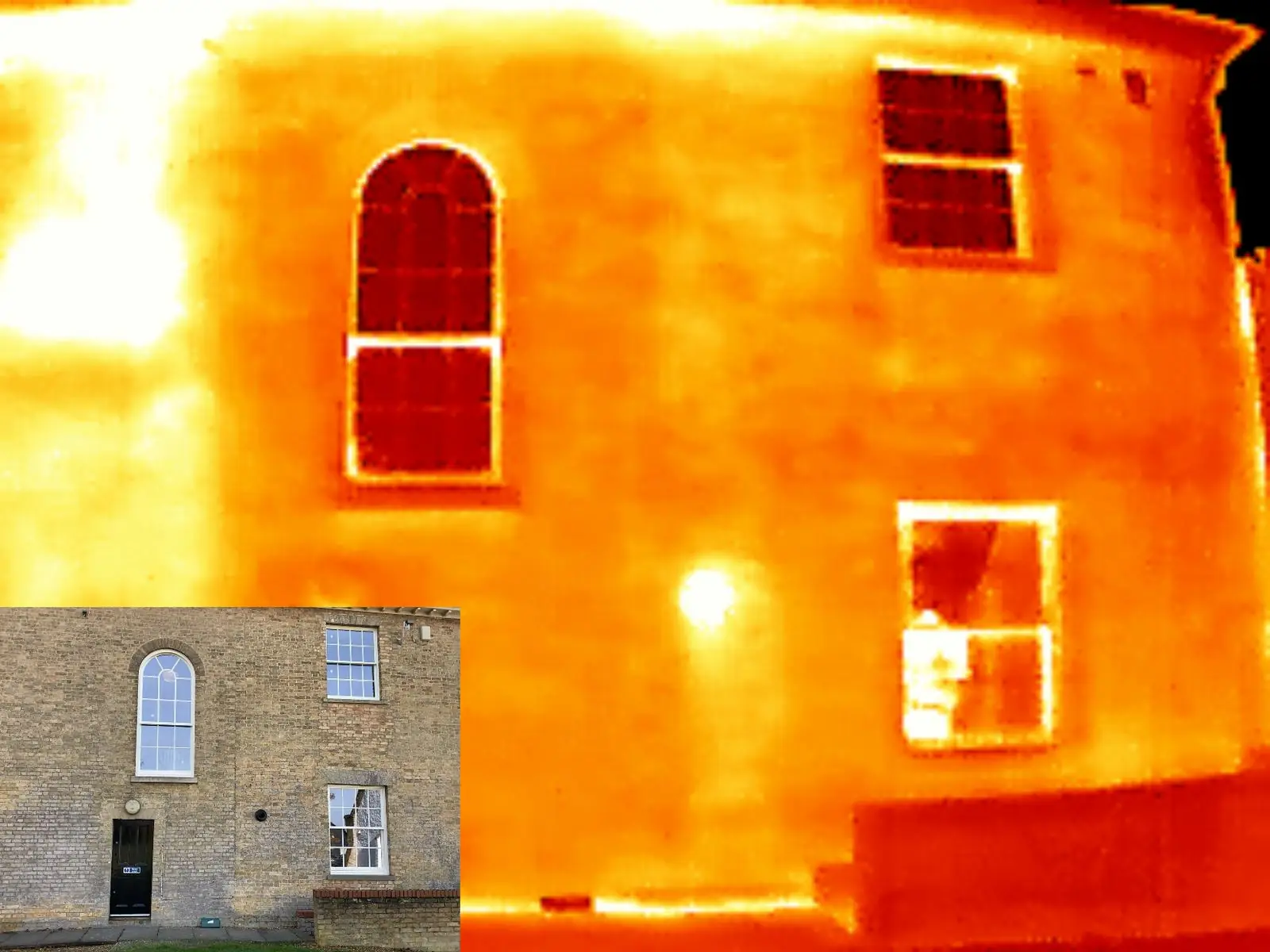 Thermal-camera scan of a period property after VIG retrofit — the sashes read darker (cooler) than the surrounding brickwork