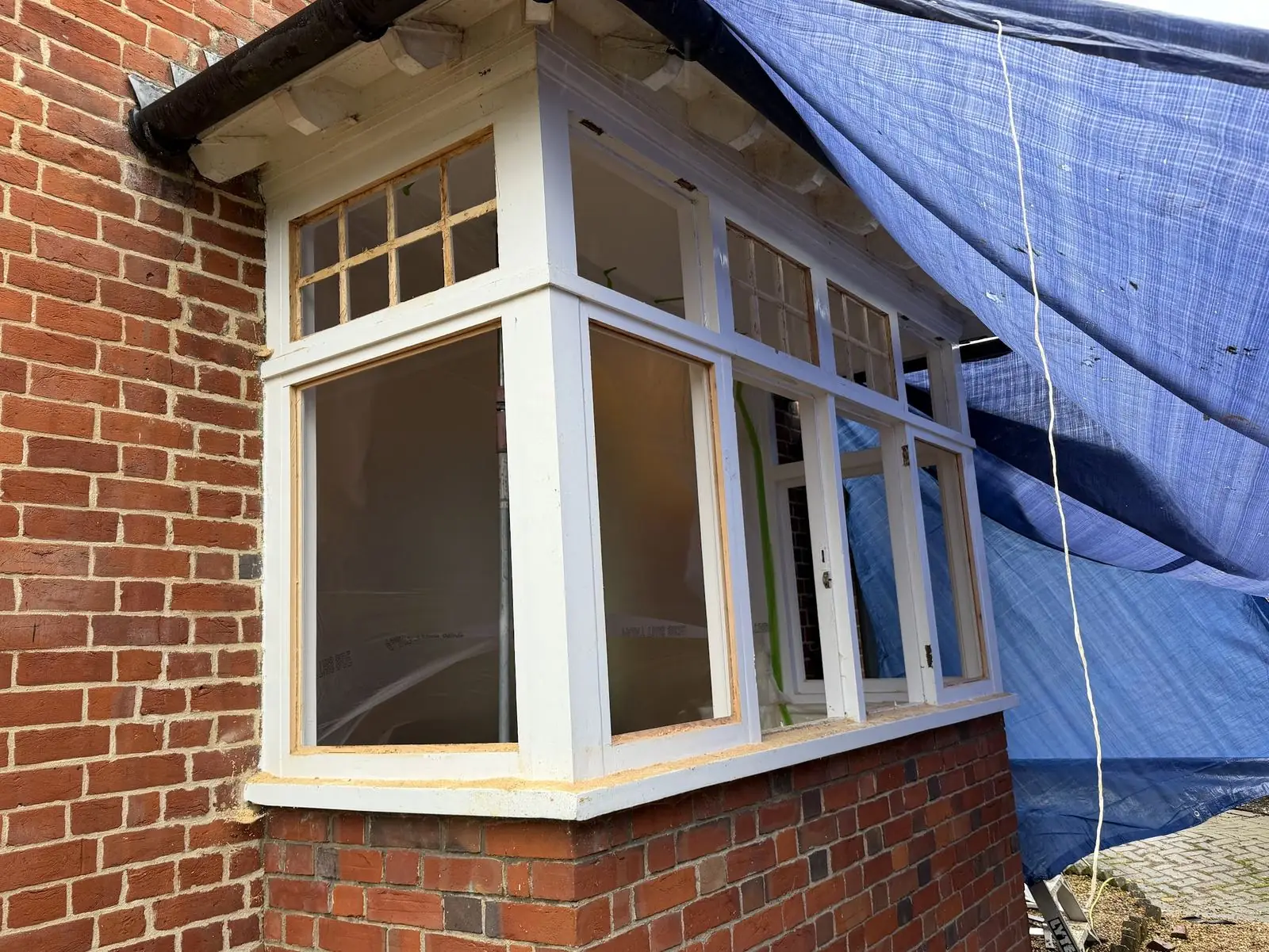 Bay window with single-pane glass removed; the existing frames routed and rebated to receive vacuum-insulated units